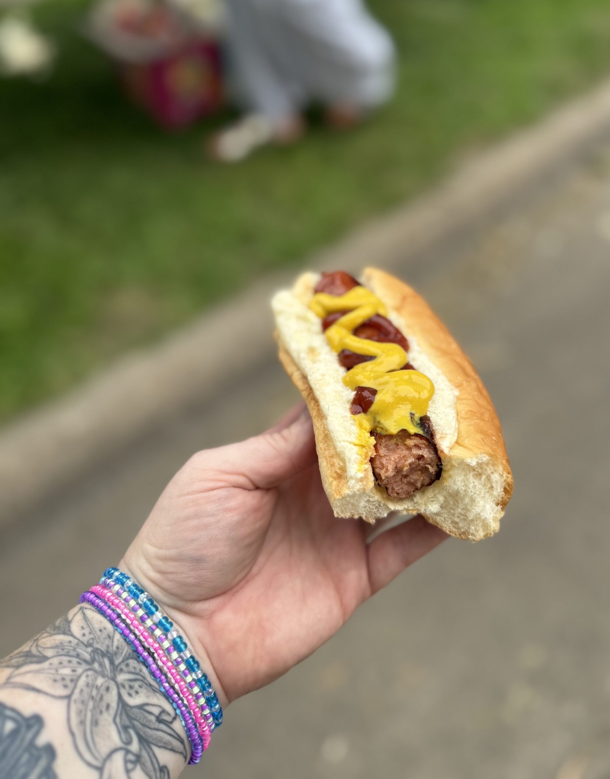 Man eating a cooked bratwurst from the best butcher shop in Robbinsdale
