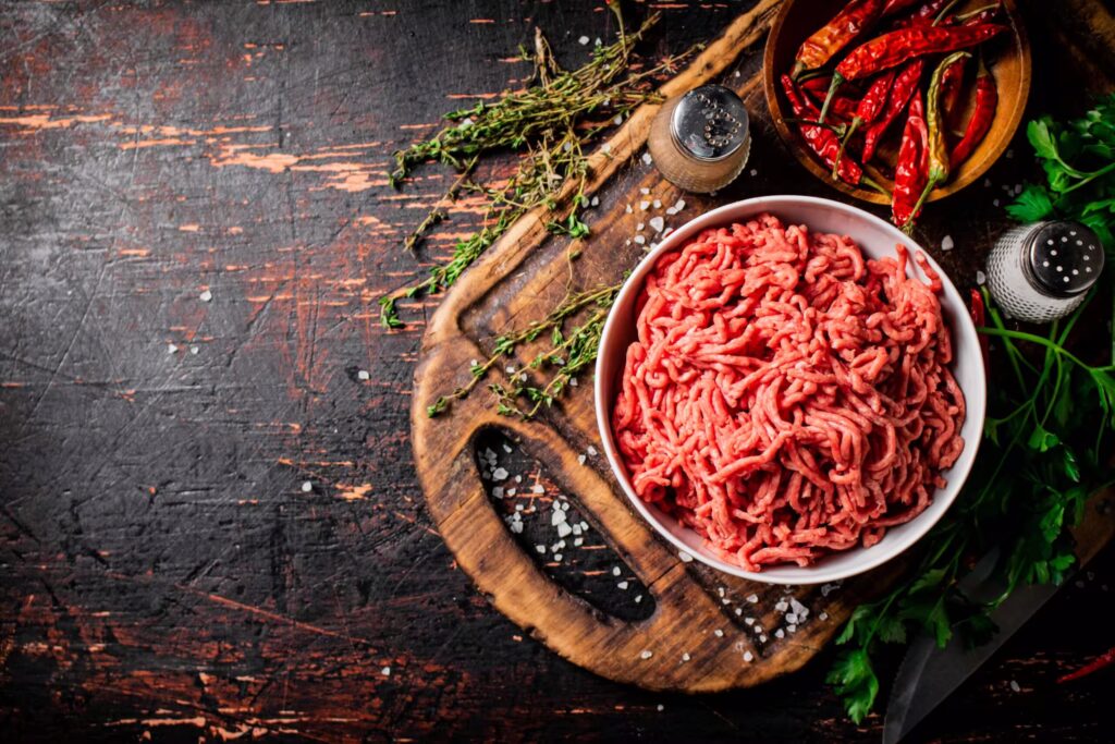 fresh-minced-meat-on-a-cutting-board-with-parsley-2024-09-23-01-18-13-utc-scaled