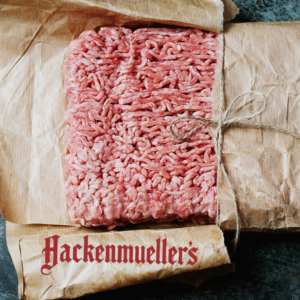 Frozen ground beef from Hackenmuellers with logo overlaid on package