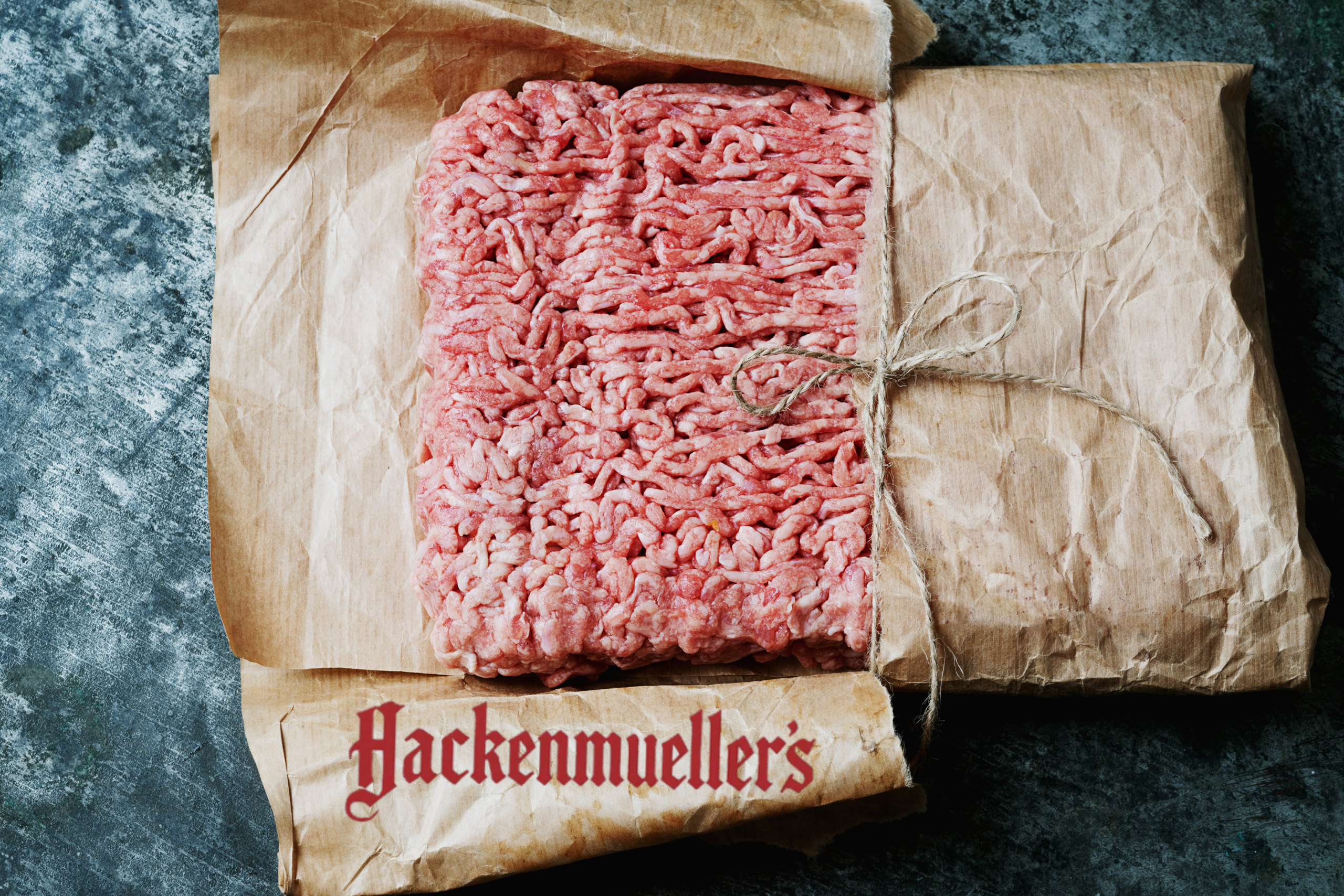 Frozen ground beef from Hackenmuellers with logo overlaid on package